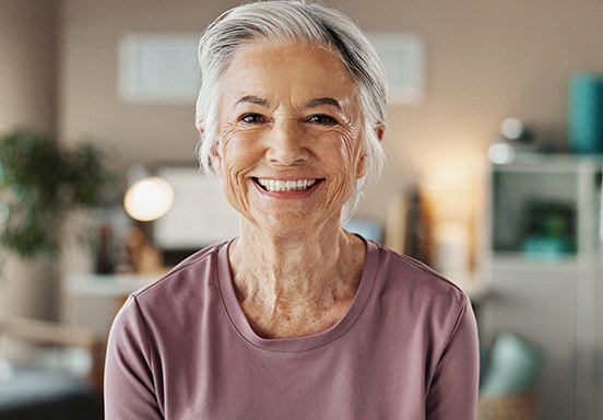 Closeup of senior woman smiling in living room