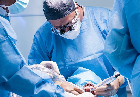 Oral surgeons performing dental implant surgery