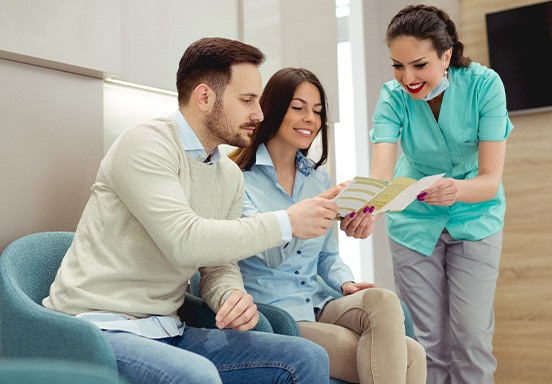 Patients asking a dentist about dental insurance at a dental clinic