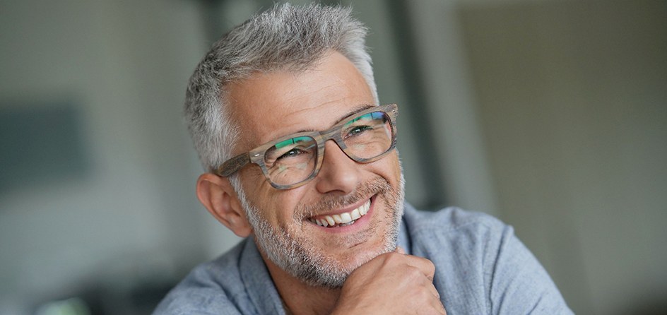 an older man smiling with bright teeth