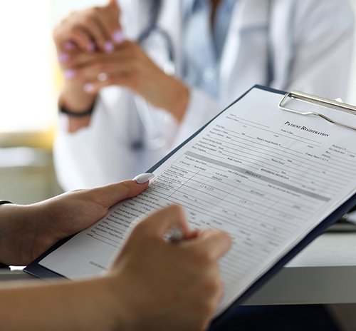 a patient filling out forms at the dentist’s office