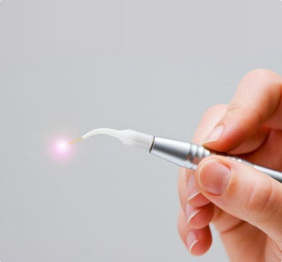 Hand holding a small dental laser device