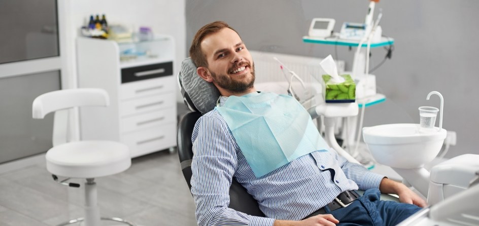 Smiling man leaning back in dental chair