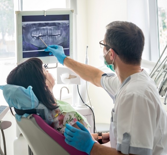 Emergency dentist showing a patient x rays of their teeth