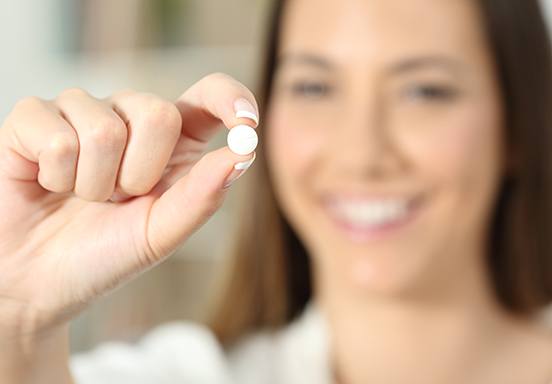 Patient holding a prescription pill