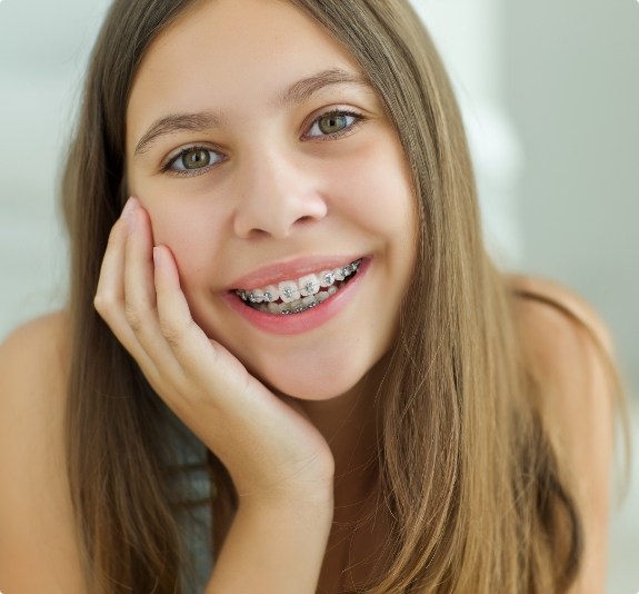 Smiling teenage girl with traditional braces