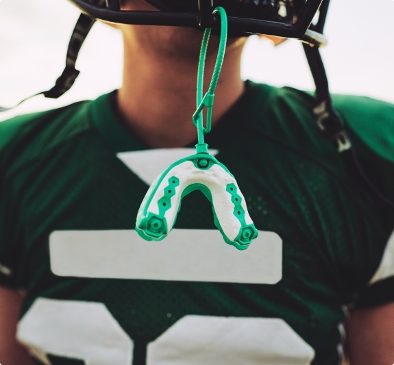 Mouthguard hanging from football helmet