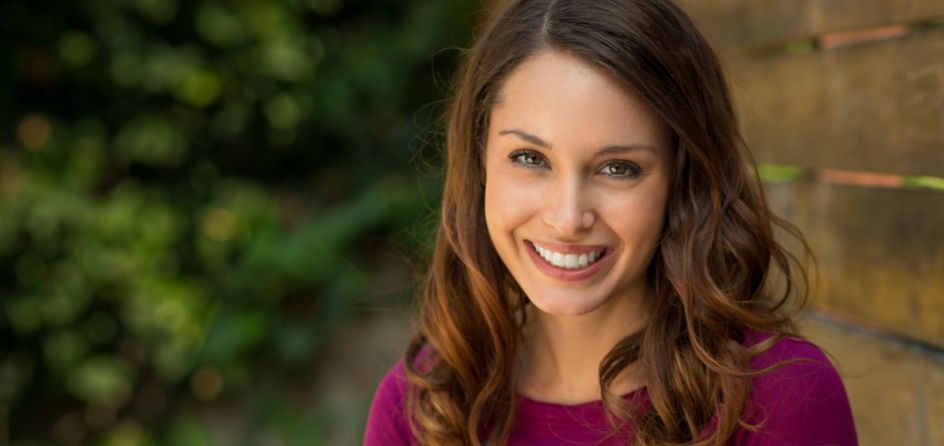 Woman in magenta blouse smiling