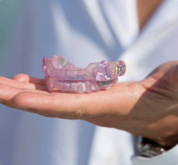 Dentist holding light purple occlusal splints