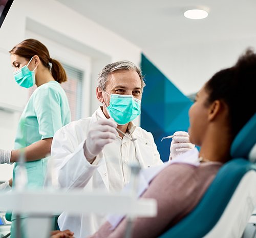 Dentist smiling at patient during checkup
