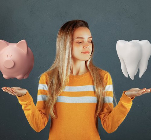 Woman balancing a piggy bank on one hand and a giant tooth model on the other