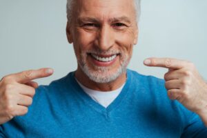 Senior man with dentures smiling. 
